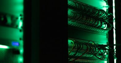 Network equipment and cables in a green-lit server rack