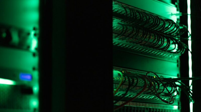 Network equipment and cables in a green-lit server rack
