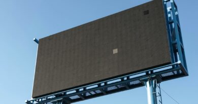 Unlit outdoor advertising billboard against a blue sky