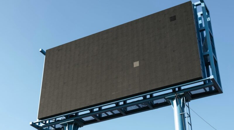 Unlit outdoor advertising billboard against a blue sky