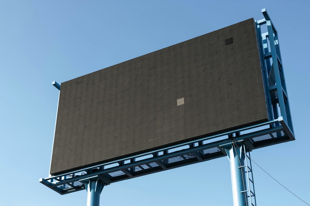 Unlit outdoor advertising billboard against a blue sky