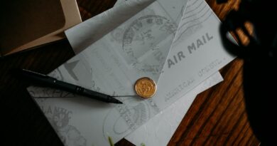 Airmail envelopes and a pen on a desk