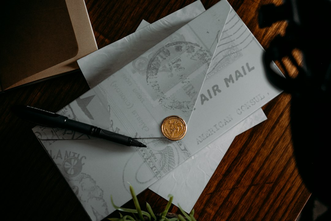 Airmail envelopes and a pen on a desk