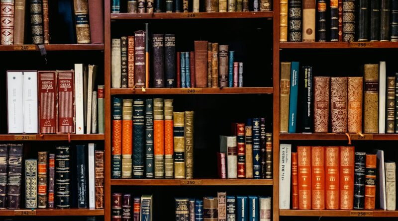Rows of books on wooden bookshop shelves
