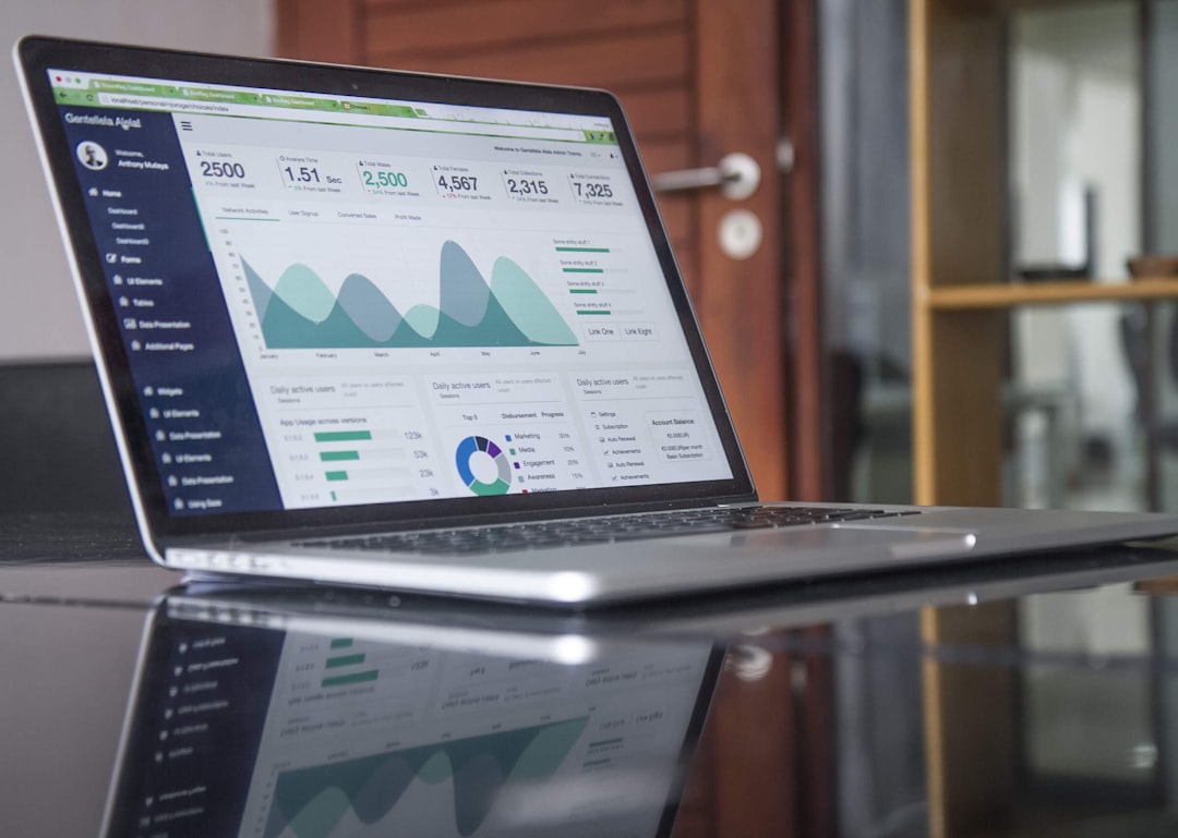 Laptop displaying charts on a desk