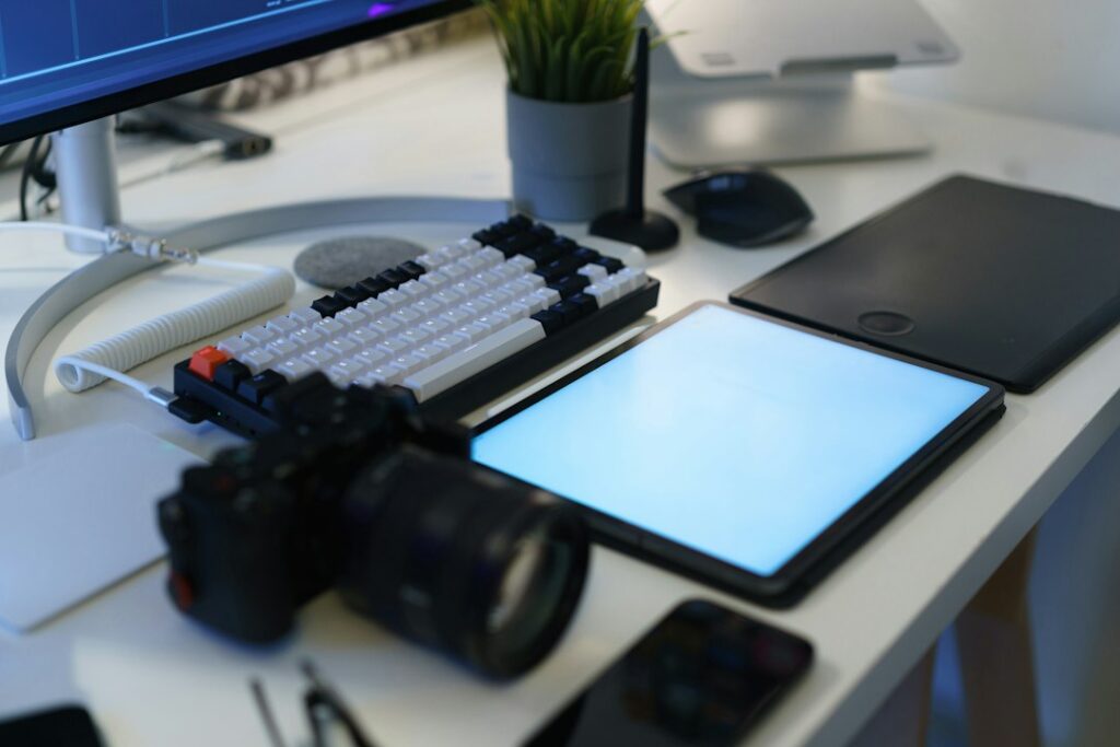 Camera, keyboard and drawing tablet on a desk