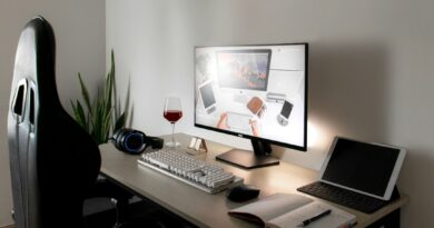 Desk with a monitor, tablet and open notebook
