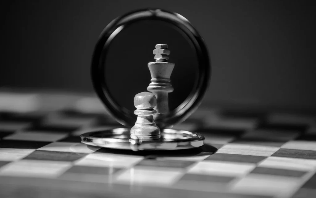 Chess pieces reflected in a round mirror on a chessboard