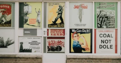 Rows of illustrated posters displayed across shop windows