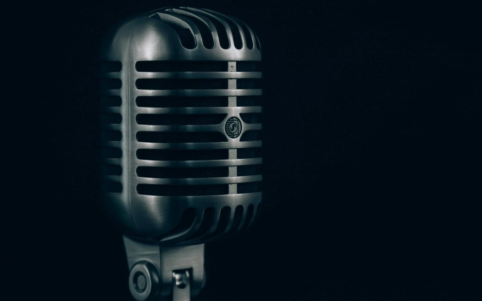A vintage microphone against a dark background