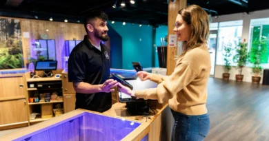 A customer and staff member talking across a retail counter