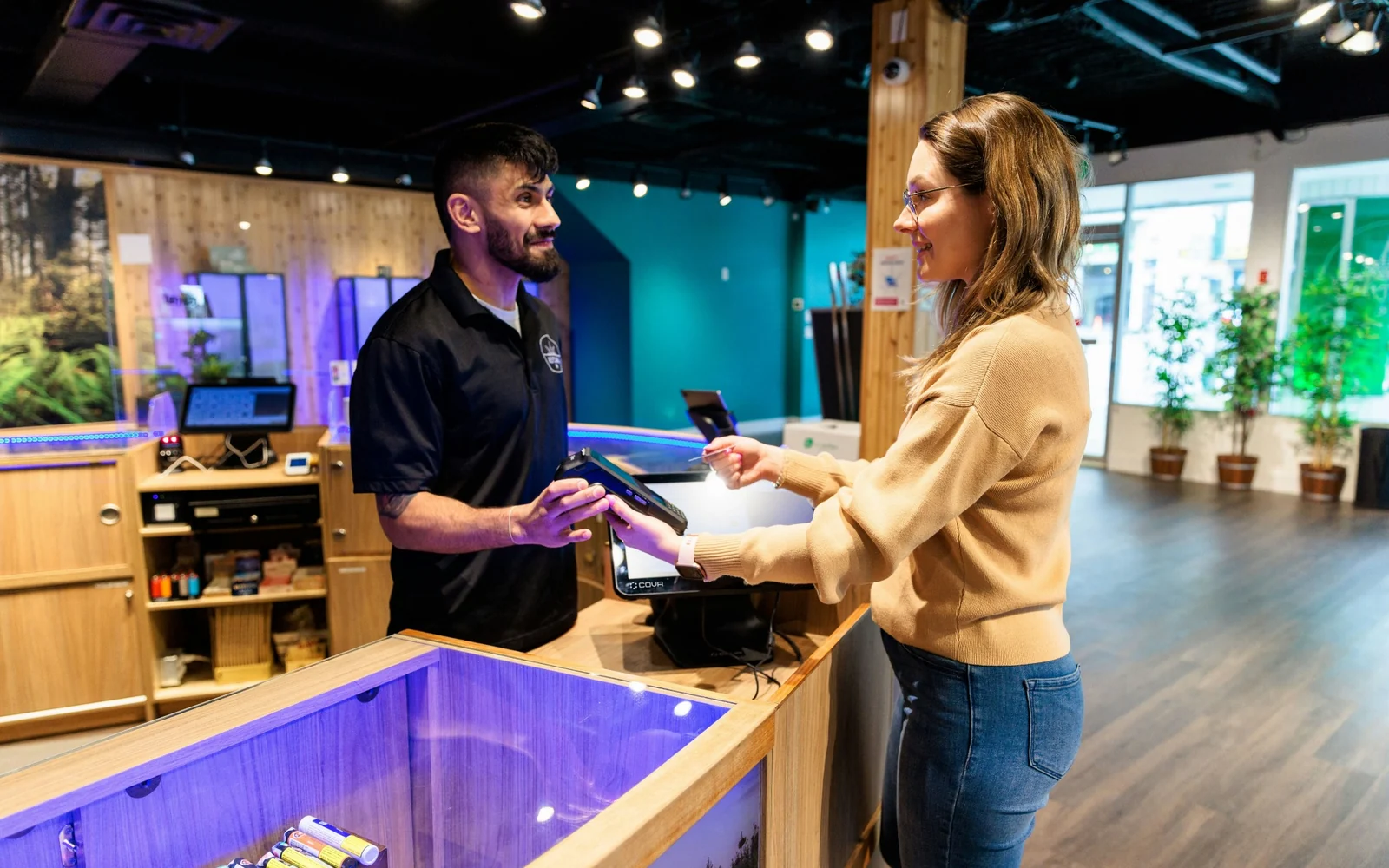 A customer and staff member talking across a retail counter
