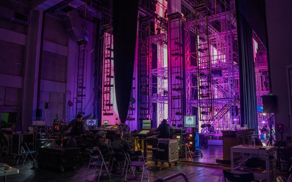 A performance venue illuminated with purple stage lighting