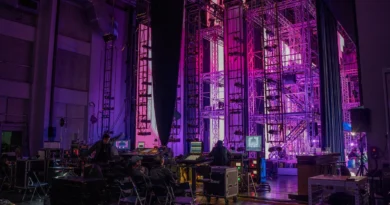 A performance venue illuminated with purple stage lighting