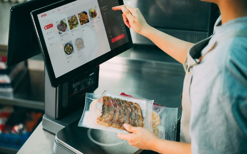 A customer selecting food on a self-service touchscreen