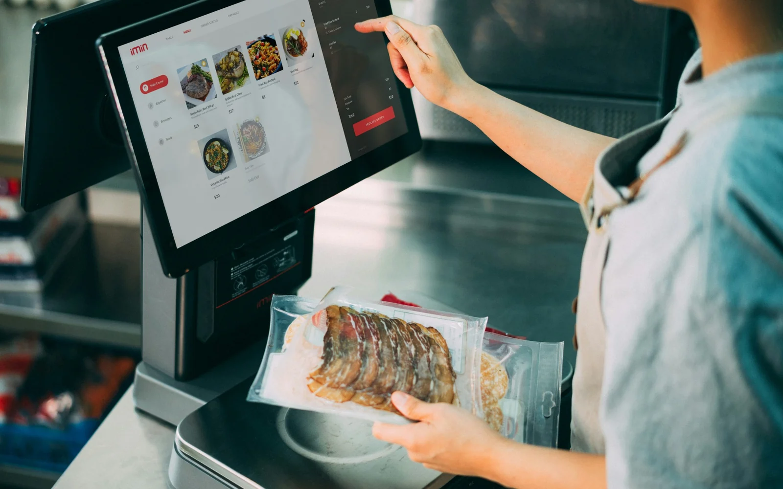 A customer selecting food on a self-service touchscreen